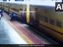 Woman trying to board a moving train slips, saved by passengers