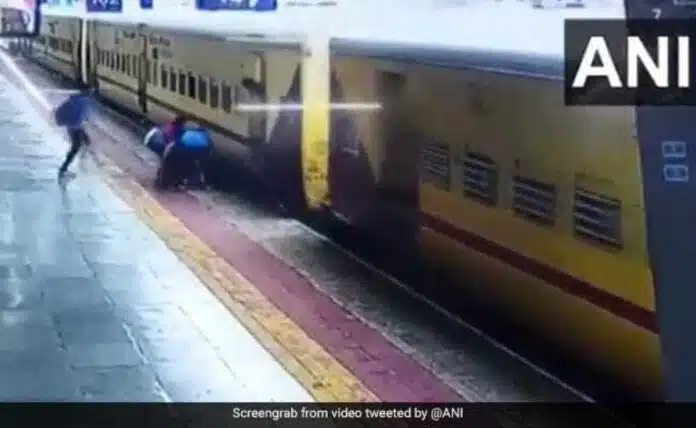 Woman trying to board a moving train slips, saved by passengers