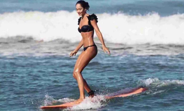 Lisa Haydon surf in Black Swimsuit