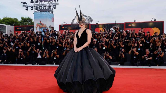 Lady Gaga in voluminous Dior gown and dramatic headpiece takes over the red carpet