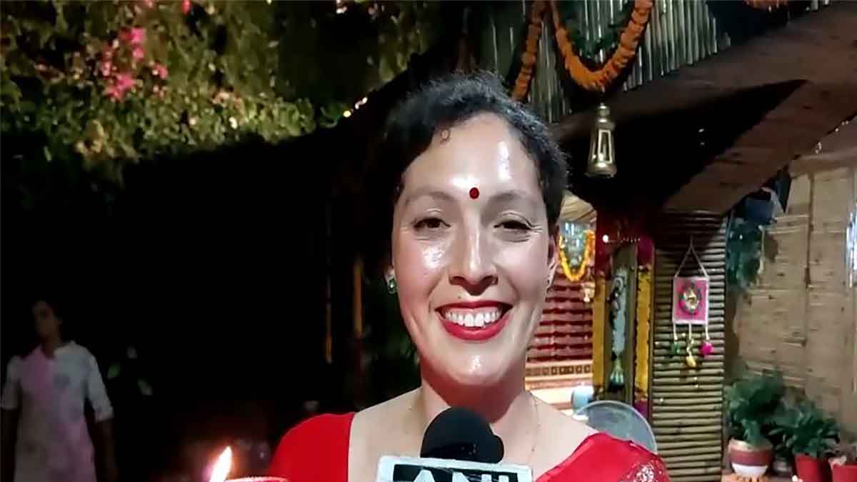 Foreign tourists perform aarti on the occasion of Diwali at Parmarth Niketan in Rishikesh