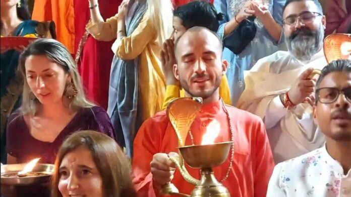 Foreign tourists perform aarti on the occasion of Diwali at Parmarth Niketan in Rishikesh