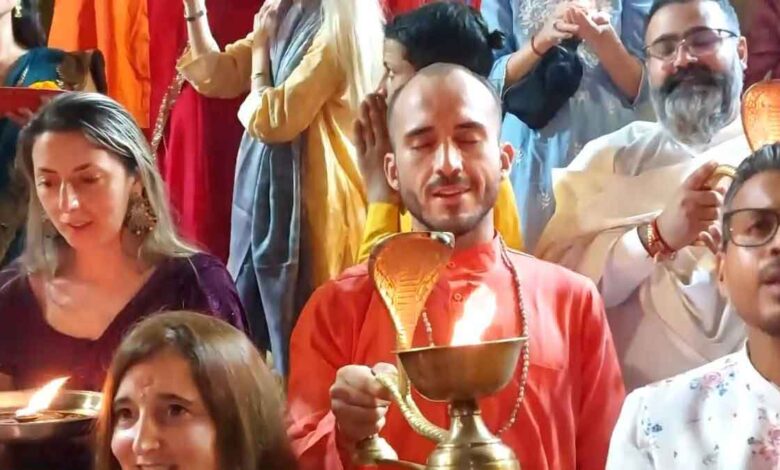 Foreign tourists perform aarti on the occasion of Diwali at Parmarth Niketan in Rishikesh