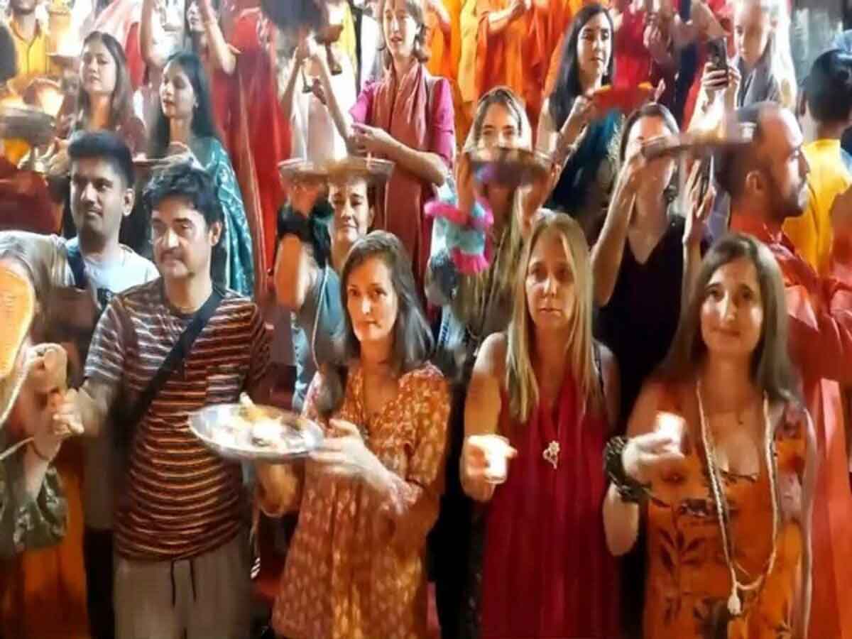 Foreign tourists perform aarti on the occasion of Diwali at Parmarth Niketan in Rishikesh