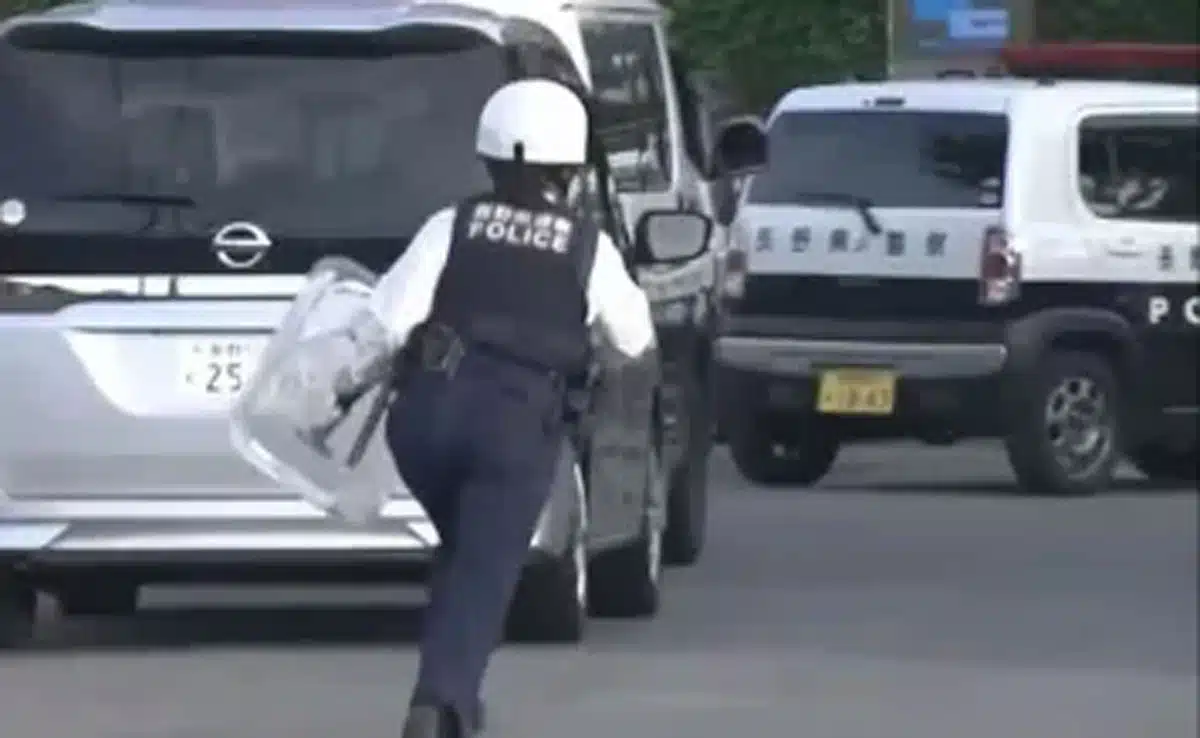 At least 14 people were injured in a stabbing and liquid spray attack at a factory in Japan; the suspect has been arrested.