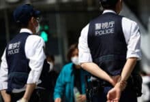 At least 14 people were injured in a stabbing and liquid spray attack at a factory in Japan; the suspect has been arrested.